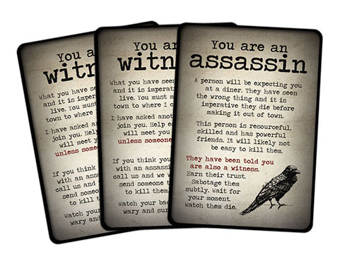 Three role cards, the front of which says "You are an assassin. A person will be expecting you at a diner. They have seen the wrong thing and it is imperative they die before making it out of town. This person is resourceful, skilled and has powerful friends. It will likely not be easy to kill them. They have been told you are also a witness. Earn their trust. Sabotage them subtly. Wait for your moment. Watch them die. 